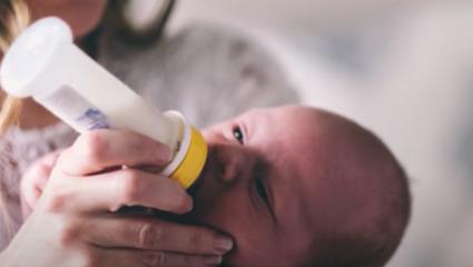 Mother bottle feeding infant