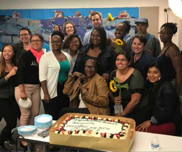 BCIs and San Francisco State masters students posing in front of a cake