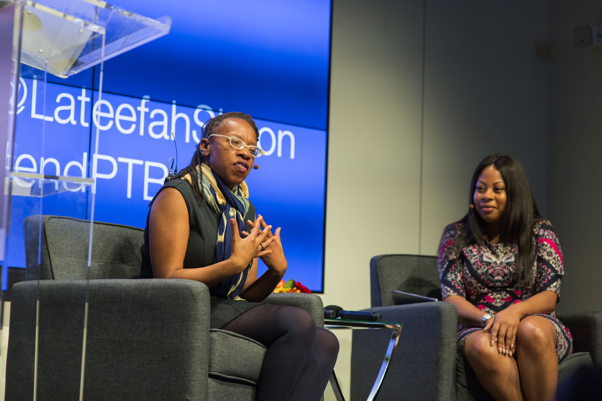 Lateefah Simon speaking on stage at symposium