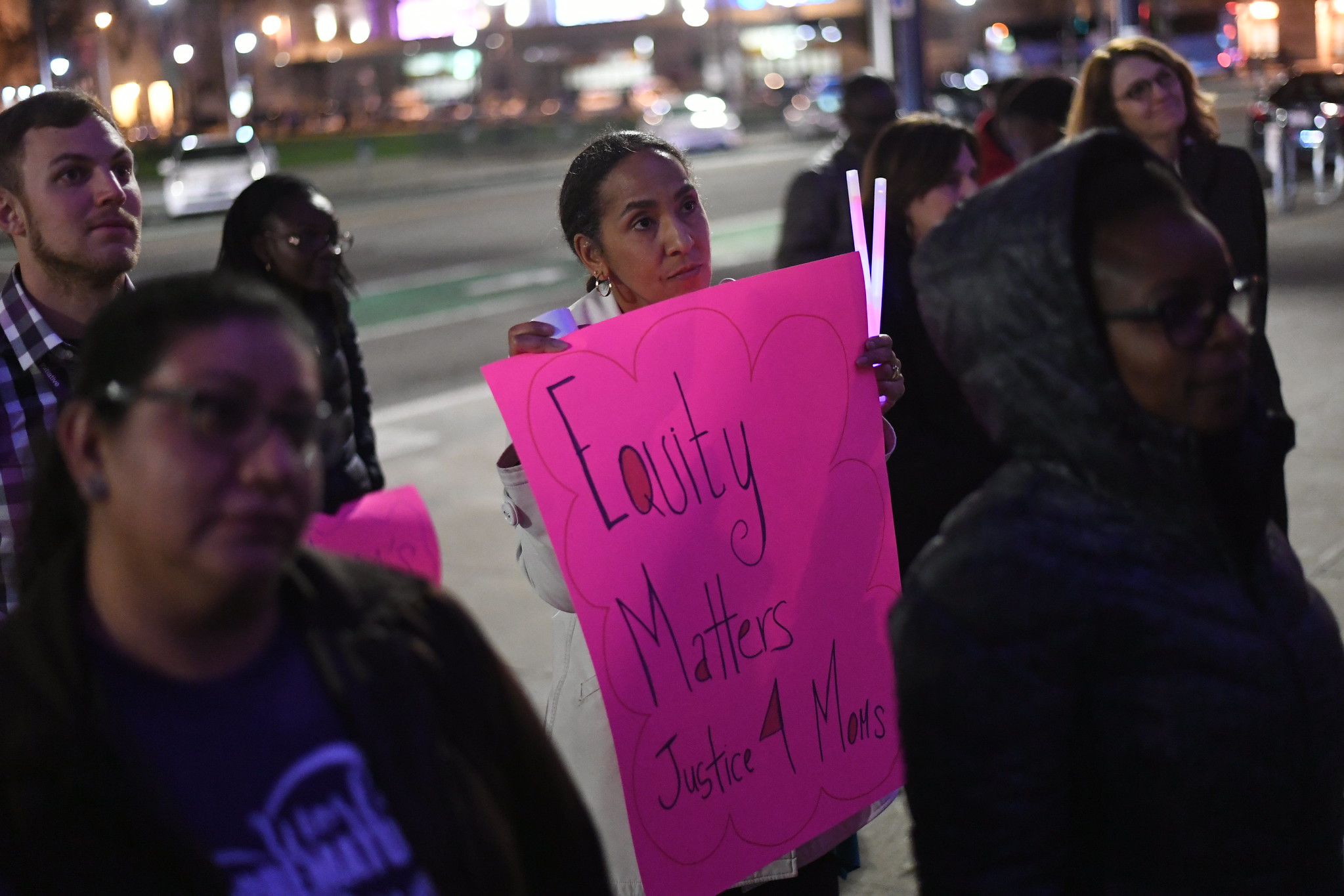 Kim coleman-phox with equity matters poster at a rally