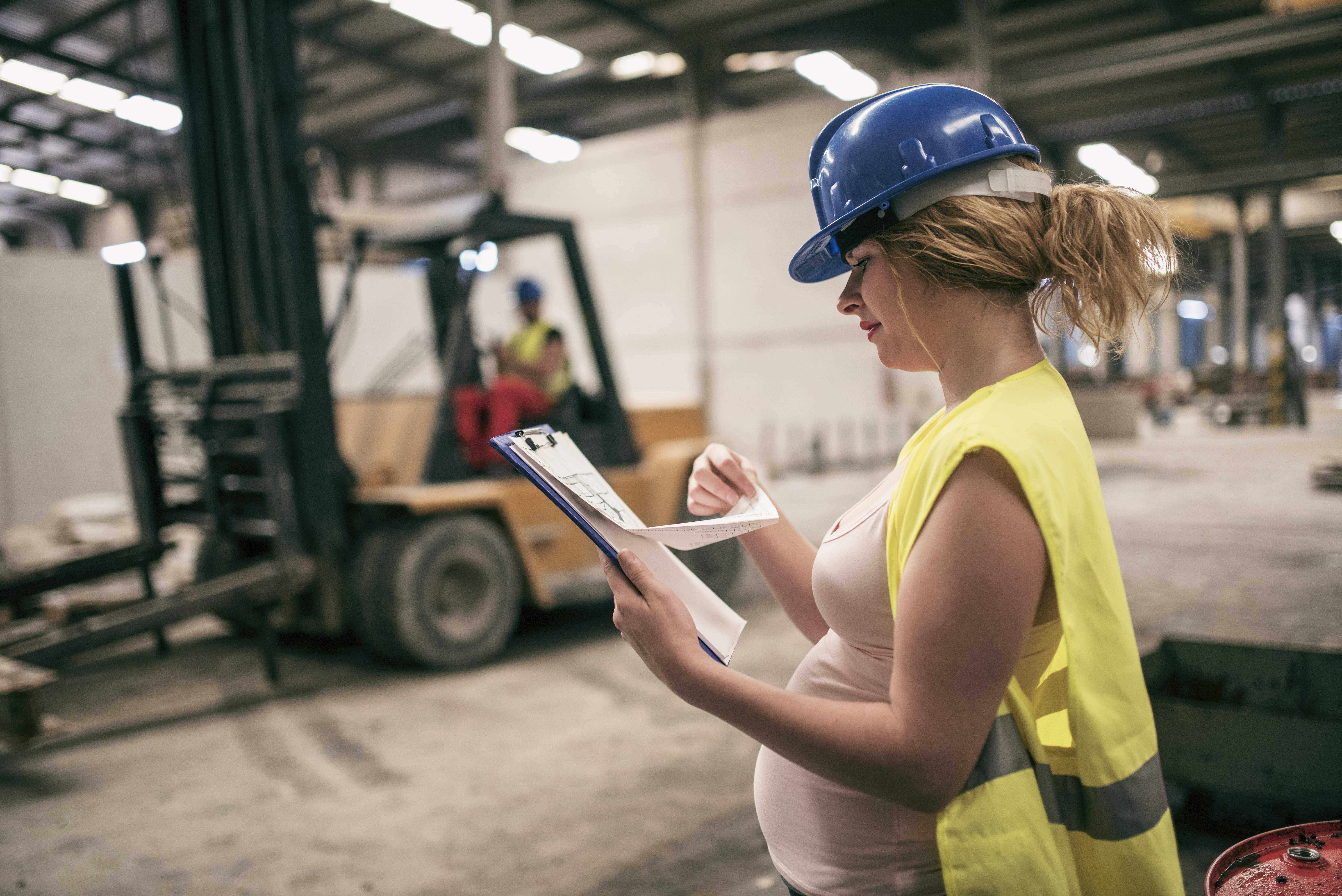 Pregnant woman working in a warehouse