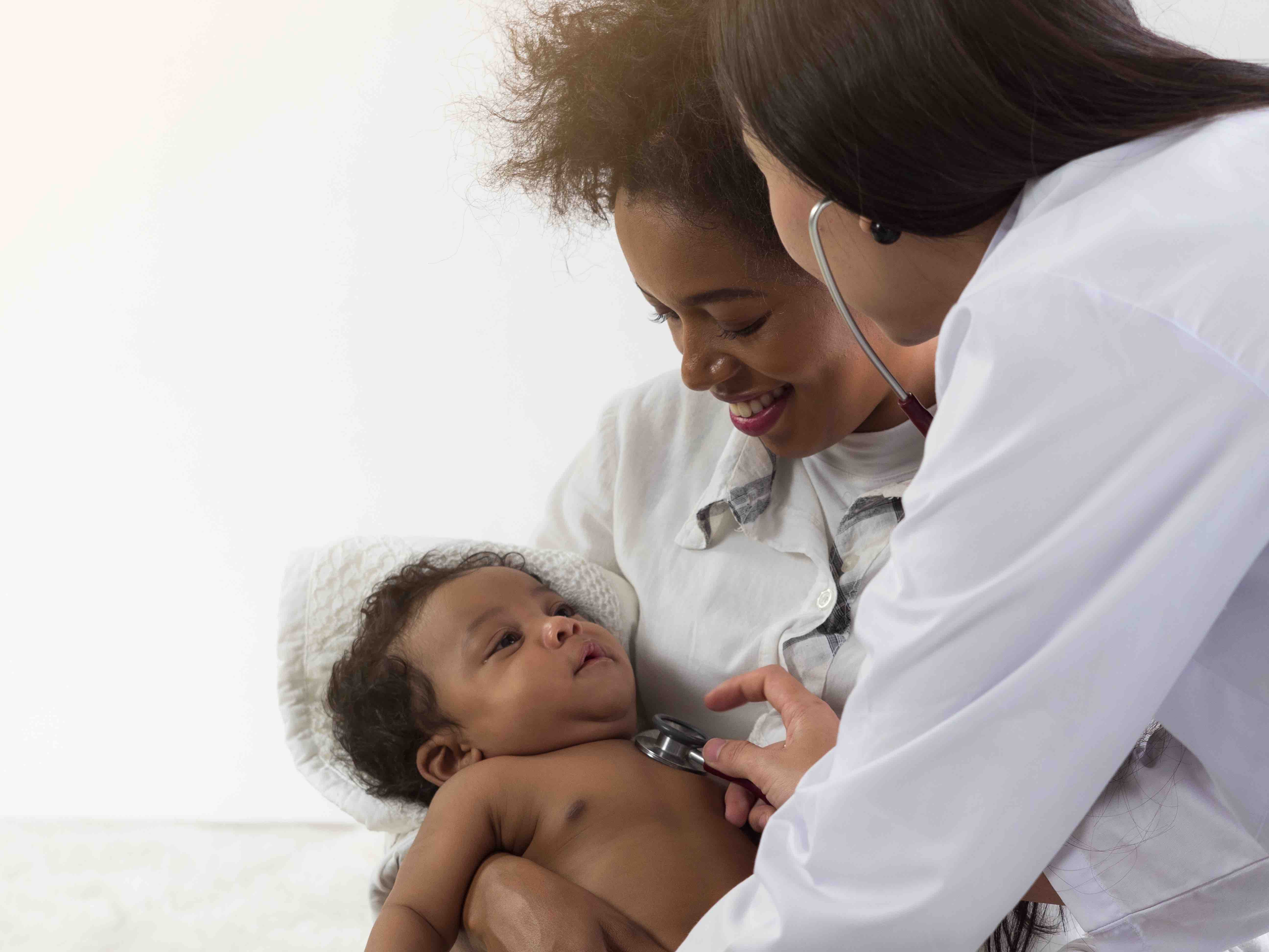 Black mother and child at postnatal visit