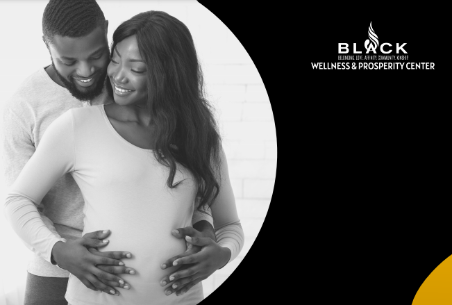 Black man with his hands around the belly of a black woman's pregnant belly smiling at each other