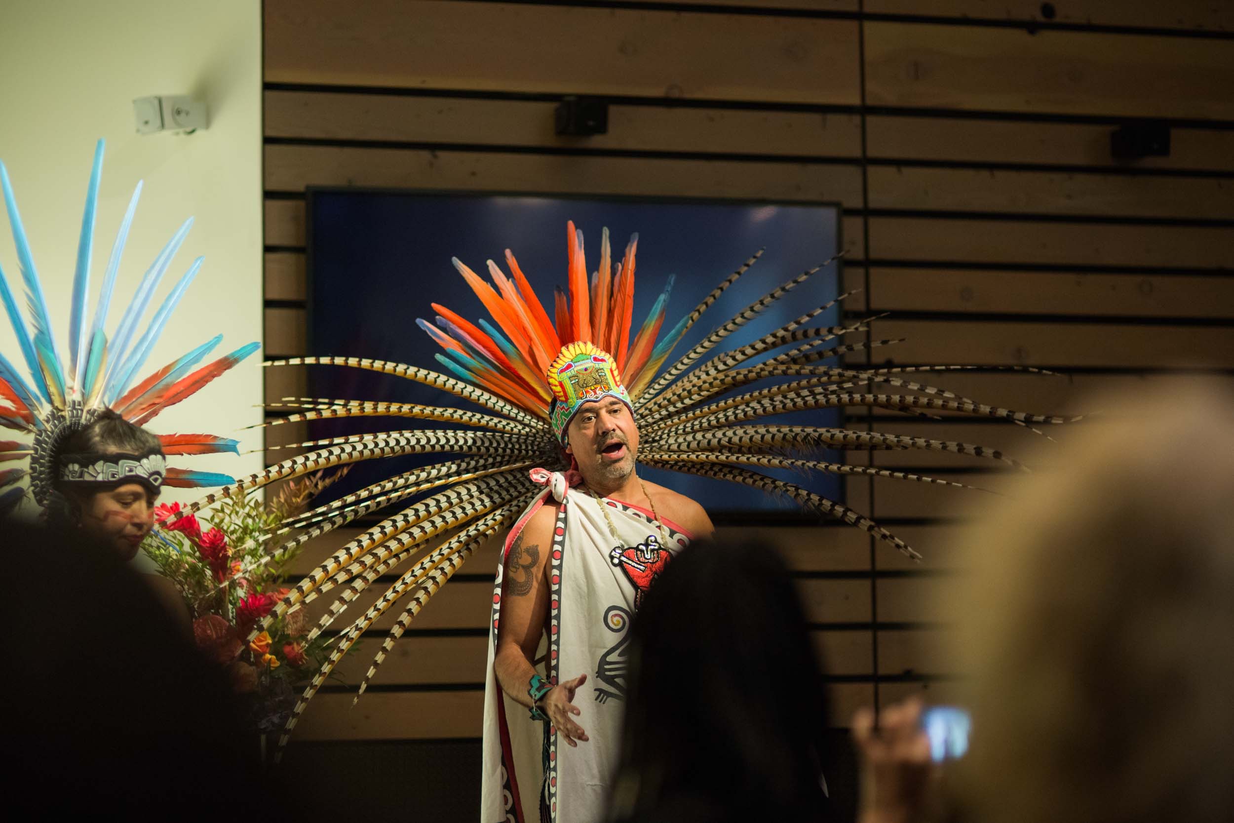 Indigenous man singing in front of a crowd at PTBi annual symposium