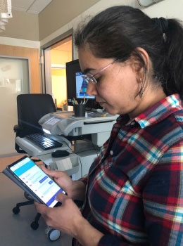 A parent uses the mFICare app (photo by Katie Millar)