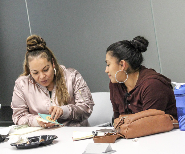 Two BCIs studying at a table